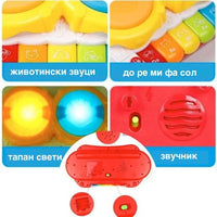 Toddlers Hand Patting Musical Drum With Piano Key